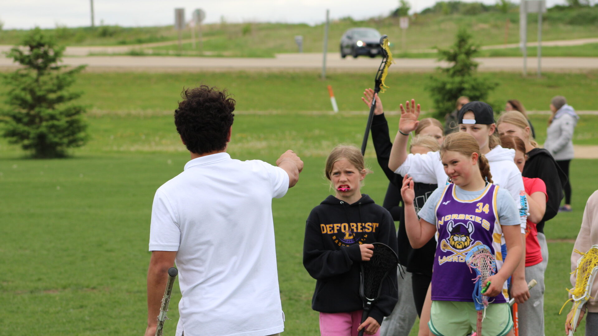 Devon Townsend Leading a Skills Group Session Devon Townsend coaching a youth skills group during an X Factor Lacrosse session, giving hands-on instruction and encouragement on the field